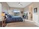 A lovely bedroom featuring a ceiling fan, large window, and a neutral palette that adds serenity to the space at 4288 Veraz St, Las Vegas, NV 89135