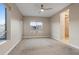 Bedroom with carpet, fan, and natural light from the large windows at 4288 Veraz St, Las Vegas, NV 89135