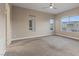 Bedroom with neutral walls, carpeted floor, and natural light from three windows at 4288 Veraz St, Las Vegas, NV 89135