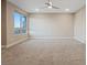 Spacious bedroom with carpet flooring, ceiling fan, and natural light from a large window at 4288 Veraz St, Las Vegas, NV 89135