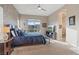 Comfortable bedroom with patterned wallpaper, large window, and access to an ensuite bathroom at 4288 Veraz St, Las Vegas, NV 89135