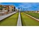Outdoor bocce ball court featuring synthetic turf, landscaping and seating with beautiful views and blue skies at 4288 Veraz St, Las Vegas, NV 89135