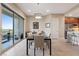 Well-lit dining space with a modern glass table and sliding door access to the outdoor patio at 4288 Veraz St, Las Vegas, NV 89135