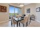 Dining room with table and chairs, a modern light fixture, and sliding glass doors to the balcony at 4288 Veraz St, Las Vegas, NV 89135