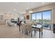 Open-concept dining room and living area with a modern glass table and outdoor balcony access at 4288 Veraz St, Las Vegas, NV 89135