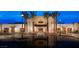 Stunning exterior view of a modern building with palm trees and reflecting pool in the driveway at 4288 Veraz St, Las Vegas, NV 89135