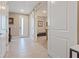 Inviting foyer with tile flooring, a modern front door and view into the carpeted living area at 4288 Veraz St, Las Vegas, NV 89135