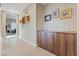 Inviting hallway with tiled flooring, elegant artwork, and a stylish storage cabinet at 4288 Veraz St, Las Vegas, NV 89135