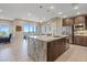 Spacious kitchen with an island, pendant lighting, stainless steel appliances, and access to the dining area at 4288 Veraz St, Las Vegas, NV 89135