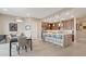 Open kitchen and dining area featuring an island with seating and stainless steel appliances at 4288 Veraz St, Las Vegas, NV 89135