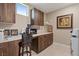 Well-organized laundry room with ample counter space, overhead cabinets, and modern appliances at 4288 Veraz St, Las Vegas, NV 89135