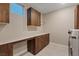 Well-equipped laundry room with custom cabinets, countertops and modern appliances at 4288 Veraz St, Las Vegas, NV 89135