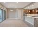 Open living space with tile floors, large windows, and a kitchen with granite countertops at 4288 Veraz St, Las Vegas, NV 89135