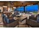 Inviting outdoor lounge area with comfortable seating, a fireplace, and scenic views of the surrounding landscape at 4288 Veraz St, Las Vegas, NV 89135
