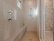 Tiled shower stall with shower head and controls, convenient built-in bench and a glass door at 4288 Veraz St, Las Vegas, NV 89135