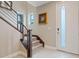 Modern staircase featuring carpeted steps, wood railing, and natural light at 4288 Veraz St, Las Vegas, NV 89135