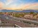 Scenic street view of a beautiful neighborhood, with palm trees and mountain views in the background at 4288 Veraz St, Las Vegas, NV 89135