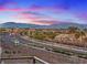 Scenic street view of a residential neighborhood with mountain views, showcasing well-maintained landscaping and community appeal at 4288 Veraz St, Las Vegas, NV 89135