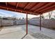 Backyard patio featuring a covered seating area, concrete foundation, and block wall perimeter at 4421 Halbert Ave, Las Vegas, NV 89110