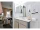 Bathroom featuring a vanity, mirror, and pink accents with an entrance to the bedroom at 4421 Halbert Ave, Las Vegas, NV 89110