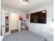 Bedroom with entertainment center, large bed, walk in closet, and modern lighting at 4421 Halbert Ave, Las Vegas, NV 89110