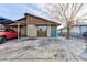 Modest single-story home featuring an attached carport and a low-maintenance front yard and teal front door at 4421 Halbert Ave, Las Vegas, NV 89110