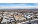 An aerial view shows a suburban neighborhood of modern homes, set against a backdrop of mountains at 472 Sand Dune Arch St, Las Vegas, NV 89138