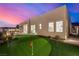 Putting green, patio, and modern design combine to create an amazing backyard at 472 Sand Dune Arch St, Las Vegas, NV 89138