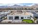 Aerial view of a backyard with a putting green, patio, and modern desert landscaping at 472 Sand Dune Arch St, Las Vegas, NV 89138