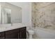 Bathroom features stylish marble tile in shower, clean white fixtures, and a dark wood vanity at 472 Sand Dune Arch St, Las Vegas, NV 89138