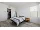 Bedroom featuring hardwood floors, a closet with a washer/dryer, and a side table at 472 Sand Dune Arch St, Las Vegas, NV 89138