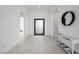 Bright entryway with tile flooring, a frosted glass door, and modern console table and mirror at 472 Sand Dune Arch St, Las Vegas, NV 89138