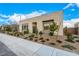 Modern single-story home with light brick exterior, tidy landscaping, and a gated entrance under a blue sky at 472 Sand Dune Arch St, Las Vegas, NV 89138