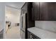 Modern kitchen space with dark cabinets and stainless steel appliances at 472 Sand Dune Arch St, Las Vegas, NV 89138