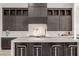 Kitchen island with seating, modern faucet, dark wood cabinets, and a white marble countertop at 472 Sand Dune Arch St, Las Vegas, NV 89138