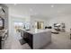 Open concept kitchen with island that has a waterfall edge, open to living and dining areas at 472 Sand Dune Arch St, Las Vegas, NV 89138