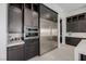 Dark cabinets surround stainless fridge and microwave in this modern kitchen at 472 Sand Dune Arch St, Las Vegas, NV 89138