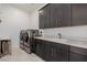 Large laundry room featuring side by side washer/dryer, sink, and cabinets for storage at 472 Sand Dune Arch St, Las Vegas, NV 89138