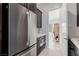 This laundry room features stainless steel appliances and access to a walk-in closet at 472 Sand Dune Arch St, Las Vegas, NV 89138