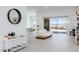 Open-concept living room featuring tile flooring, a modern sofa, and sliding doors to the patio at 472 Sand Dune Arch St, Las Vegas, NV 89138