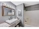 Bathroom featuring an elegant framed mirror above the sink and a shower/tub with a white shower curtain at 478 Potomac St, Henderson, NV 89015