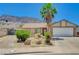 Charming single-story home featuring a palm tree in the front yard and a backdrop of picturesque mountains at 478 Potomac St, Henderson, NV 89015