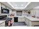 Well-lit kitchen with granite countertops, black appliances, and ample counter space for cooking at 478 Potomac St, Henderson, NV 89015