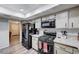 Functional kitchen with black appliances, light wood cabinets, and granite countertops at 478 Potomac St, Henderson, NV 89015