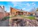 Spacious backyard with a fire pit, pool, and solar panels on the roof at 4932 Goldeneye Way, North Las Vegas, NV 89031