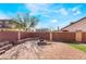 Open backyard featuring brick pavers, a brick fire pit, and a secure, block perimeter wall at 4932 Goldeneye Way, North Las Vegas, NV 89031