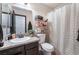 Bathroom includes vanity with granite countertop, toilet, storage and decorative plant at 4932 Goldeneye Way, North Las Vegas, NV 89031