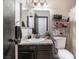 Bathroom vanity with sink, dark cabinets, granite countertop, and a mirror with lighting at 4932 Goldeneye Way, North Las Vegas, NV 89031