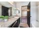 Updated bathroom vanity with granite counters, mirrors, and access to a shower and bedroom at 4932 Goldeneye Way, North Las Vegas, NV 89031