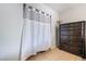 Bedroom closet with curtain and dark wooden dresser at 4932 Goldeneye Way, North Las Vegas, NV 89031